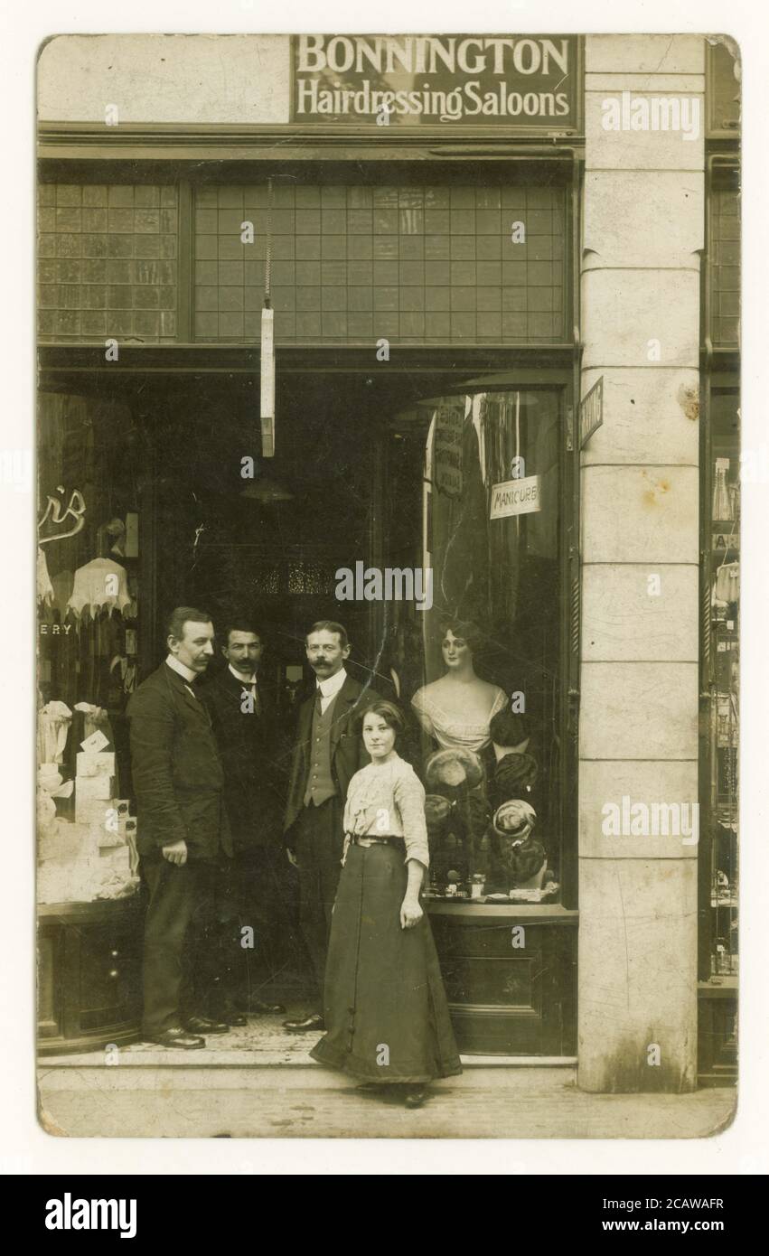 Early 1900's original postcard of staff posing outside a department store. A Bonnington hairdressing saloons sign above the dooer and another sign in the window says Hairdressing and shampooing Saloon, a female mannequin with coiffured hair is seen in the window, U.K, circa 1912 Stock Photo