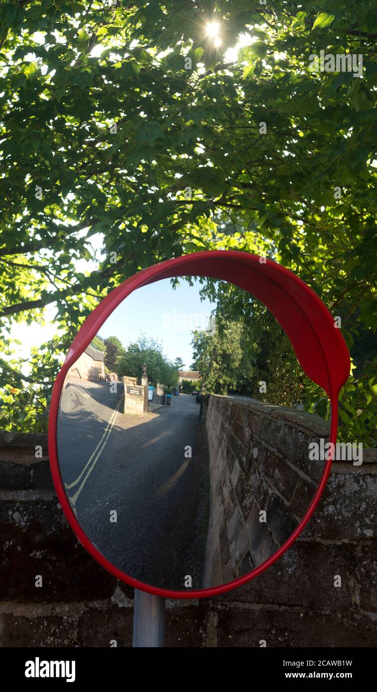 Convex road safety mirror by Warwick Castle car park, Castle Lane, Warwick, UK Stock Photo