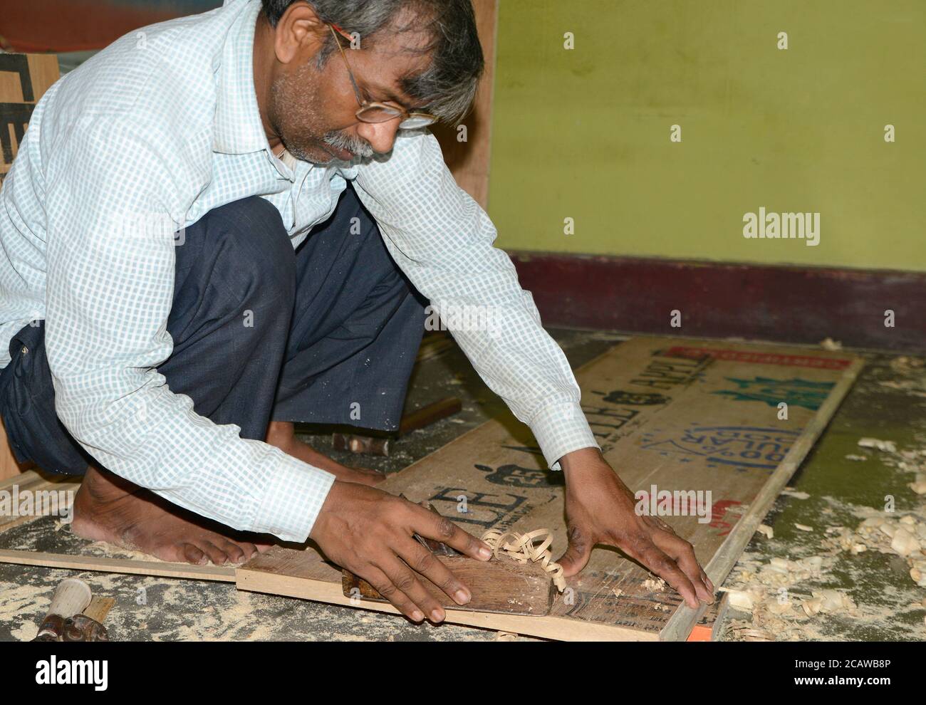 A carpenter working on wood by using old tools Stock Photo - Alamy