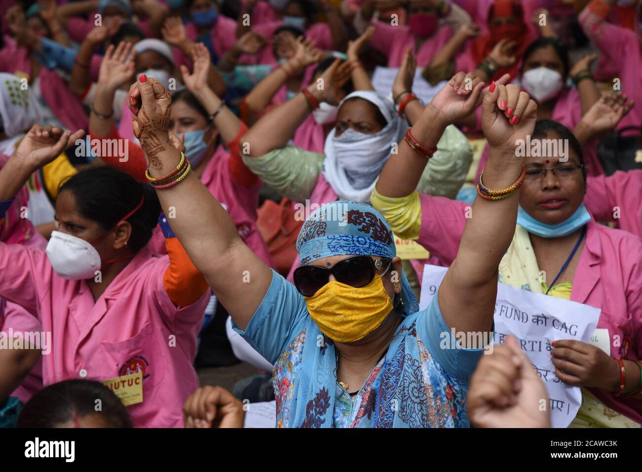 Health workers in New Delhi, India on Sunday August 09, 2020 demanding unpaid wages of the last 5 months by governiment. Accredited Social Health Activists (Asha) in Delhi are currently engaged in pandemic management work, such as conducting door-to-door surveys, especially in the containment zones, putting up posters outside Covid-19 patients' homes, keeping tabs on people in home isolation and supplying medicines at their doorsteps. Photograph: Sondeep Shankar Stock Photo