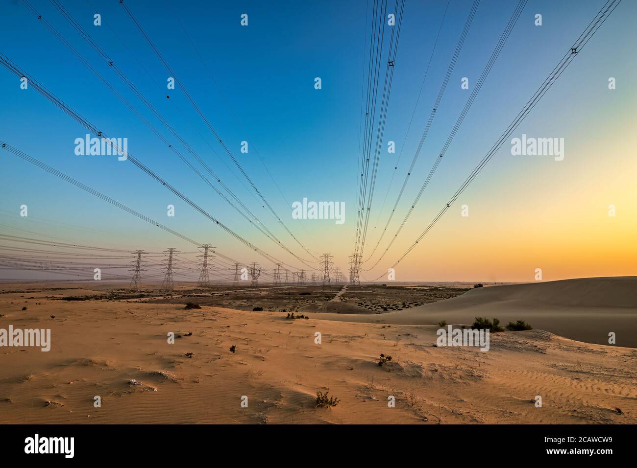 High voltage electric tower on sunrise time near Al Hofuf -Saudi Arabia. Stock Photo