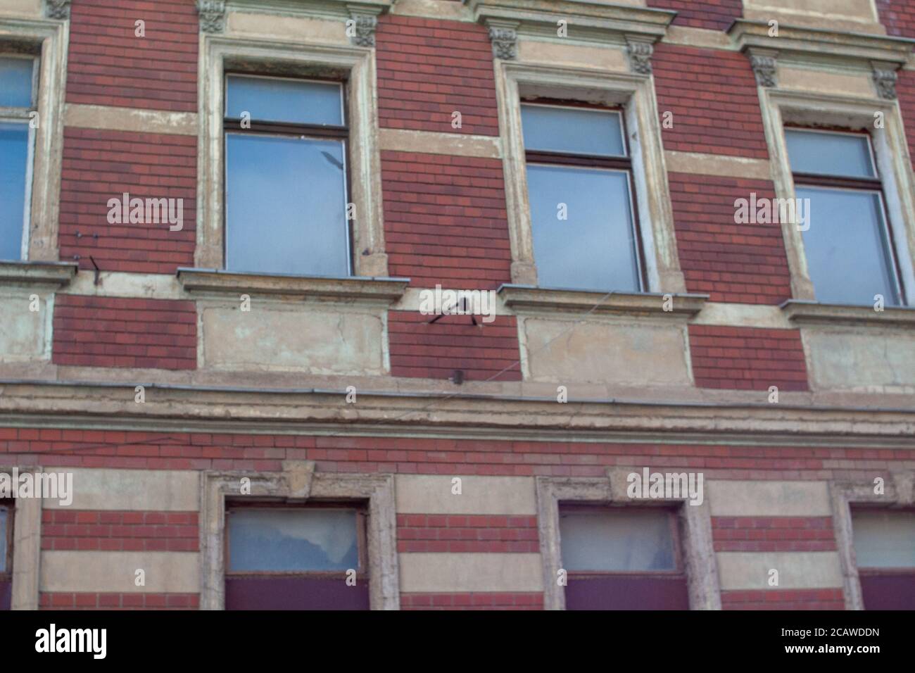 Low angle shot of the facade of an old building with red walls and ...