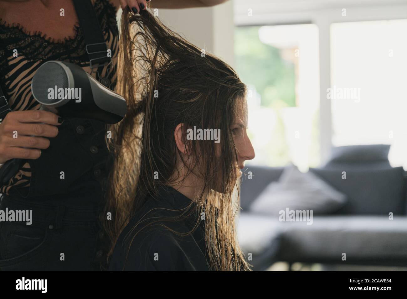 Hairdresser drying long hair client hi-res stock photography and images ...