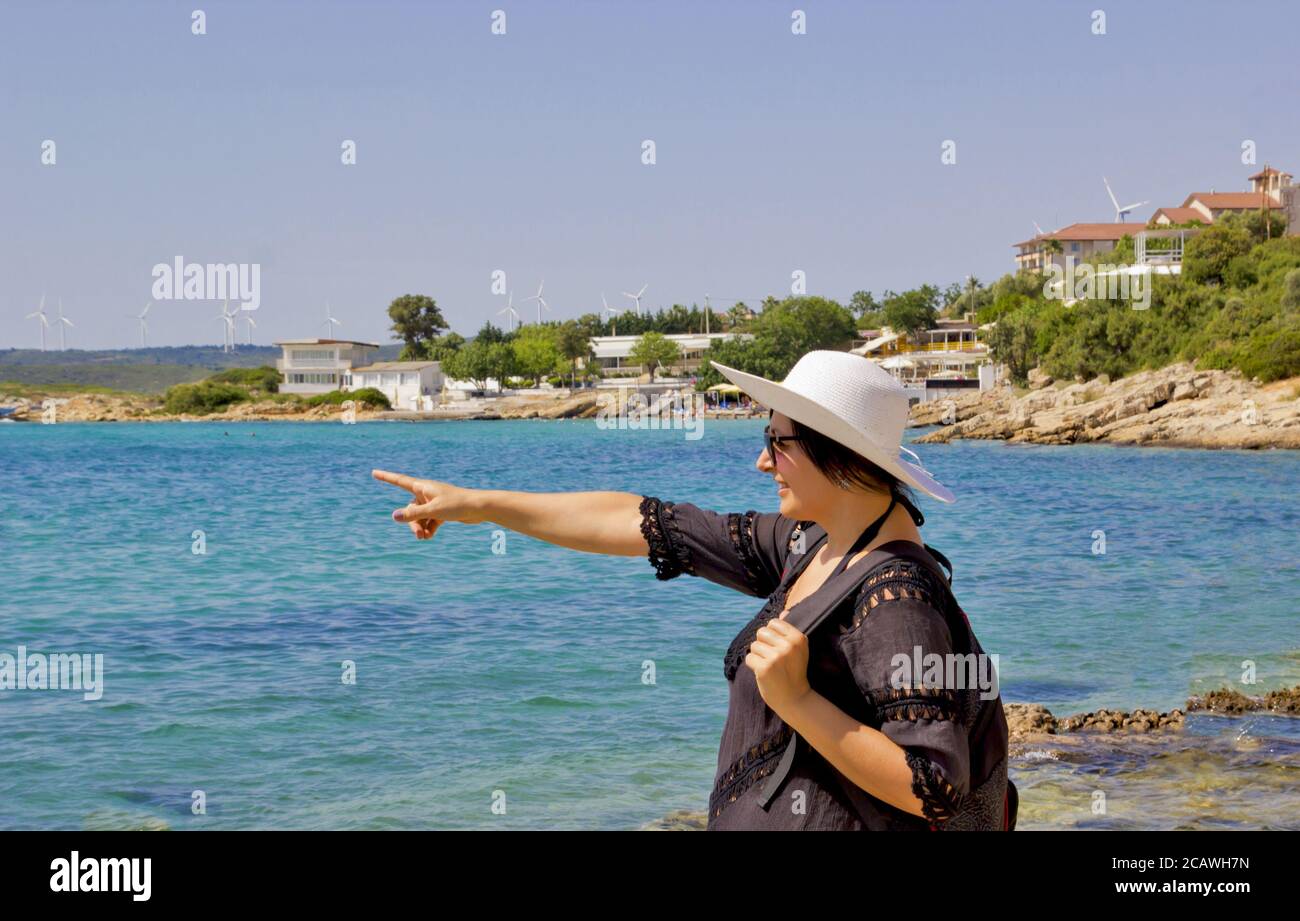 beautiful young woman in a white hat on the beach Stock Photo - Alamy