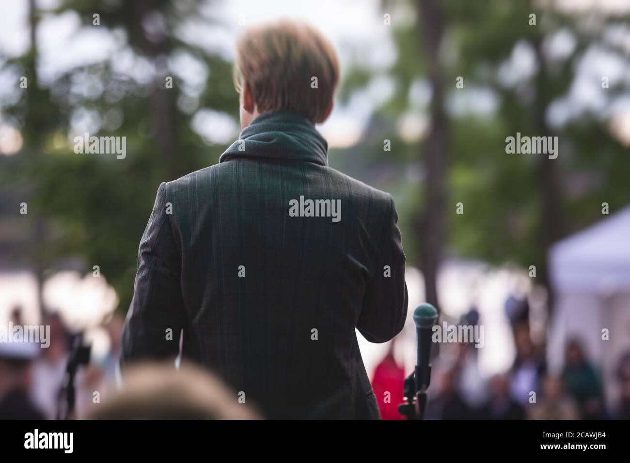 View of jazz vocalist singer with microphone performing on a stage with