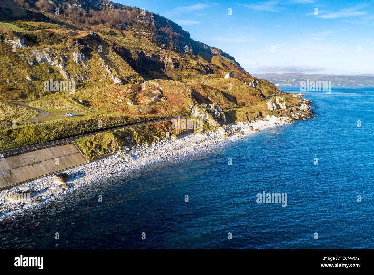 The eastern coast of Northern Ireland and Causeway Coastal Route a.k.a Antrim Coast Road A2. One of the most scenic coastal roads in Europe. Aerial vi Stock Photo