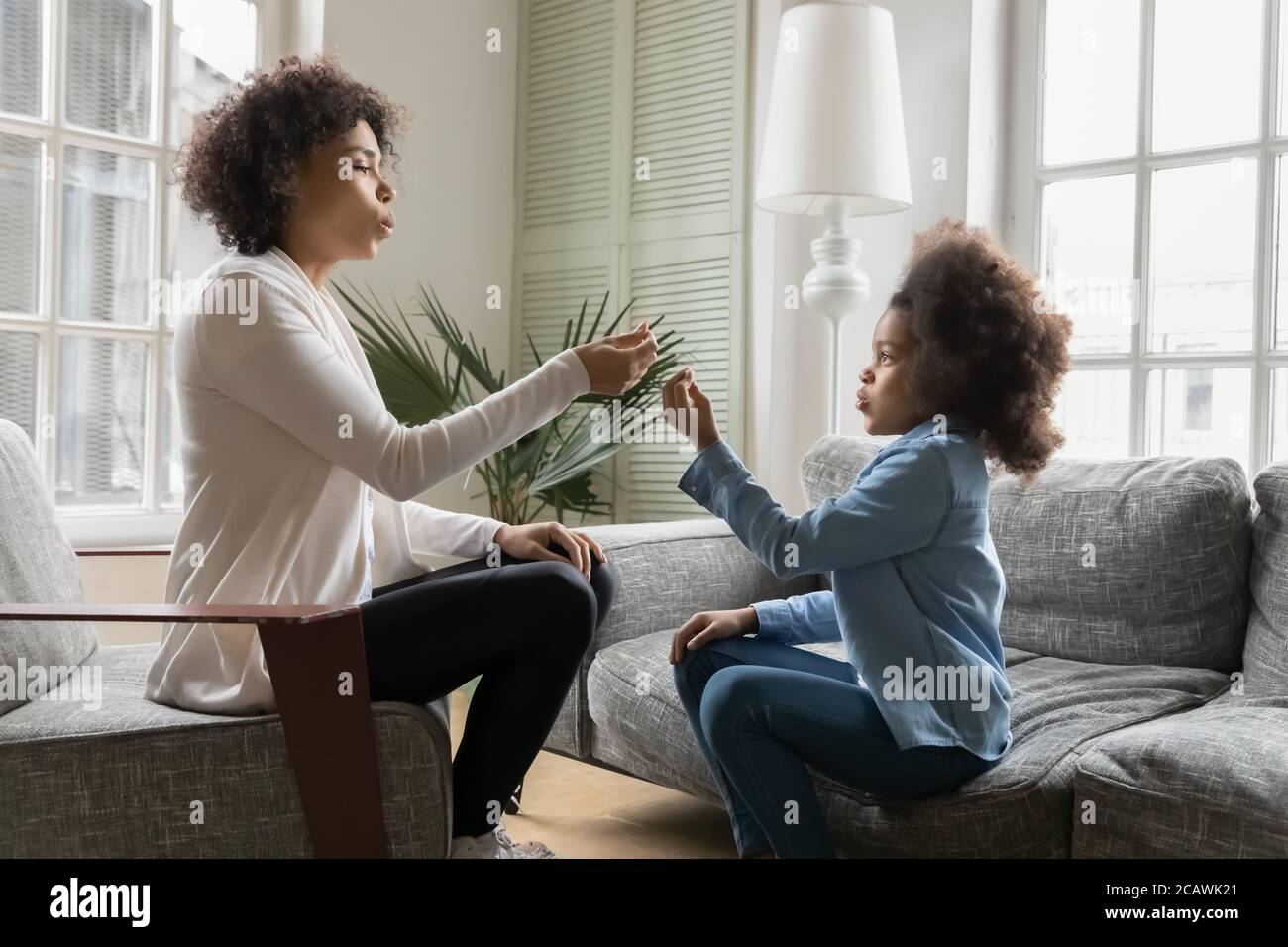 African American girl learn pronouncing with speech therapist Stock Photo