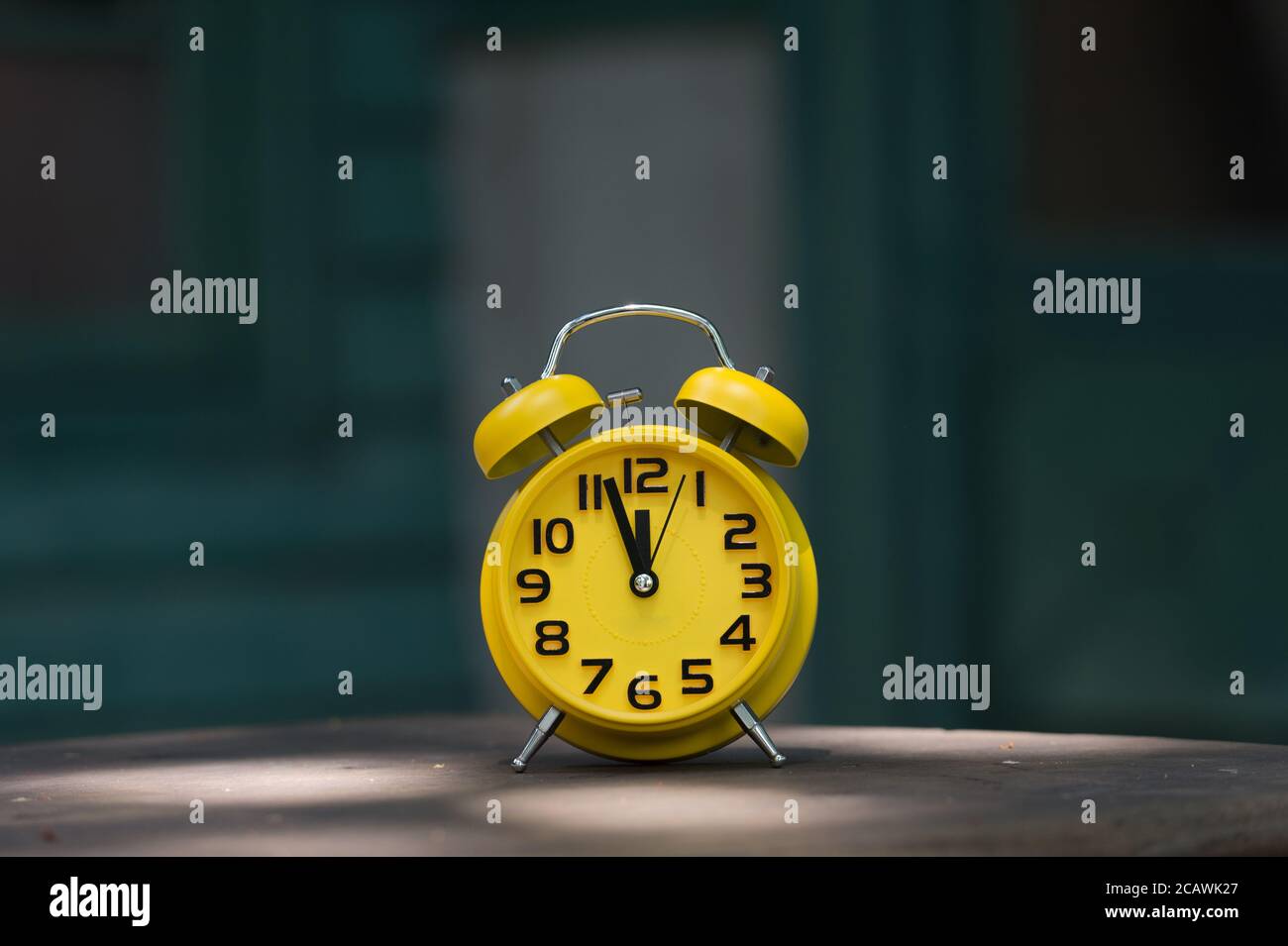 Retro alarm clock with five minutes to twelve o'clock Stock Photo Alamy