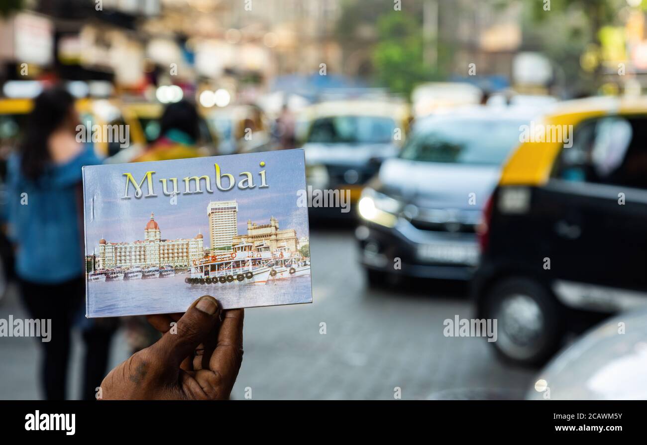 Postcard booklet of Mumbai with blurred city in background Stock Photo