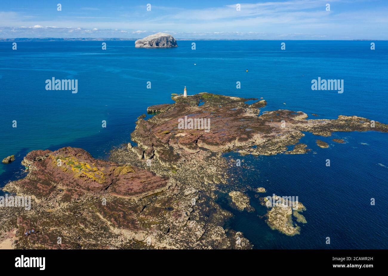 A view of the Bass Rock from St. Baldred's Boat, a crescent of rocks out from Seacliff Beach which is marked with large cross, East Lothian, Scotland. Stock Photo