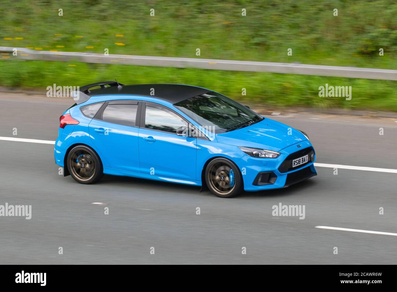 2018 Blue Ford Focus RS Edition 4X4 with spoiler; Vehicular traffic moving vehicles, cars driving vehicle on UK roads, motors, motoring on the M6 motorway highway network. Stock Photo