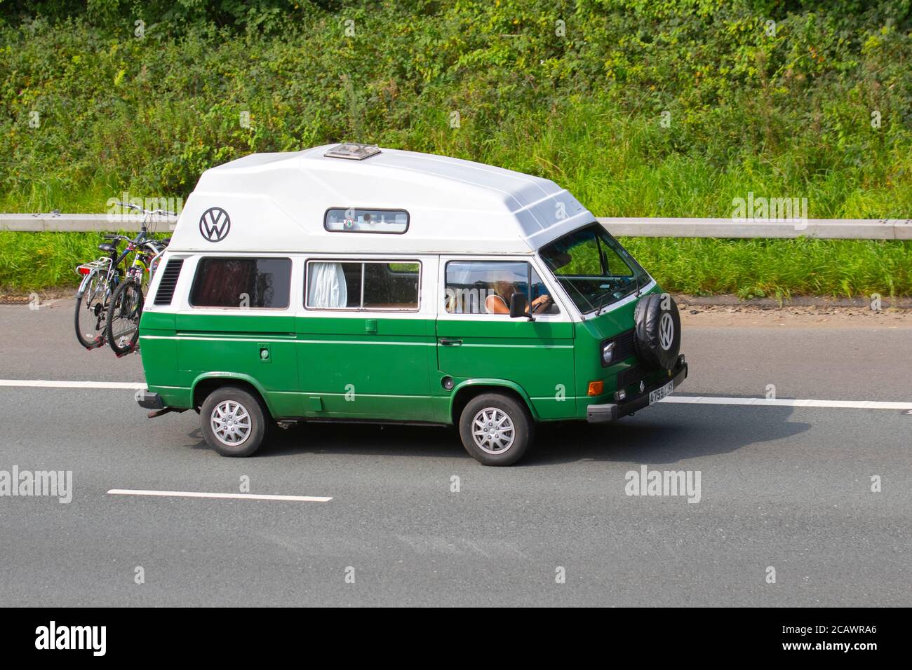 1983 80s green white Volkswagen Caravelle 78Ps; Caravans and Motorhomes, campervans on Britain's roads, RV leisure vehicle, family holidays, caravanette vacations, Touring caravan holiday, van conversions, Vanagon autohome, classic cars, cherished veteran, restored old timer, collectible motors, vintage heritage, old preserved, collectable, resto VW vans. Stock Photo