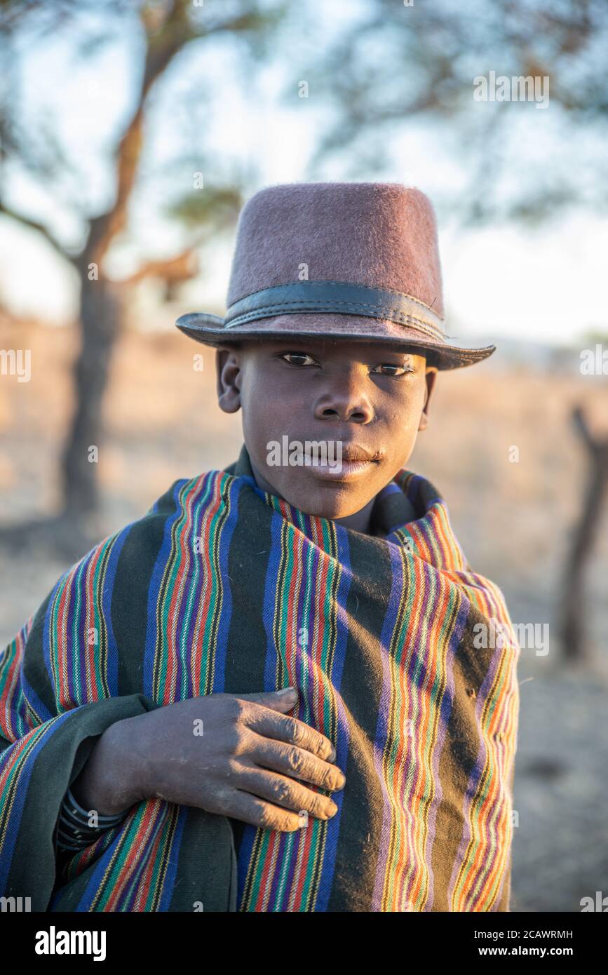 Young Karamojong cattle herder with traditional blanket and hat, Moroto District, Uganda Stock Photo