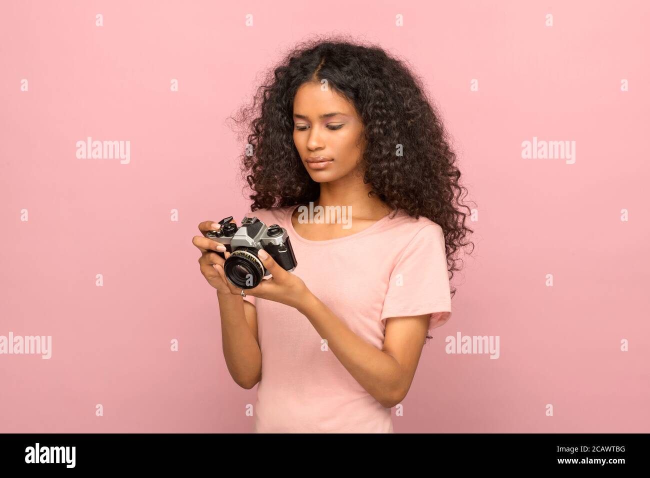 Young black female photographer chimping checking her image on the back ...
