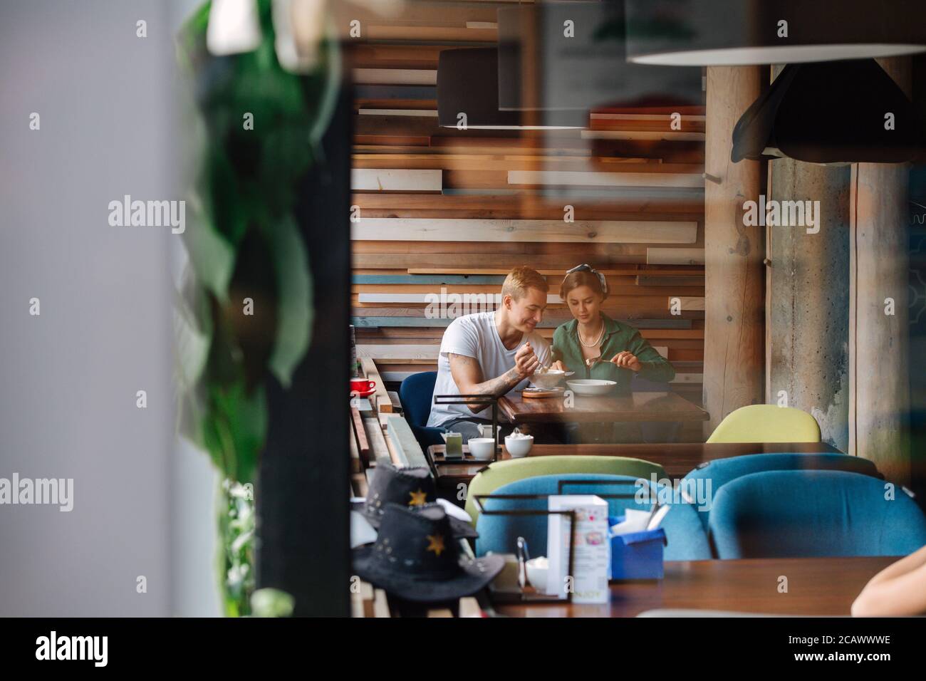 Tow People On Date In Cafe Eating In The Corner On The Same Side Of A Table Stock Photo Alamy