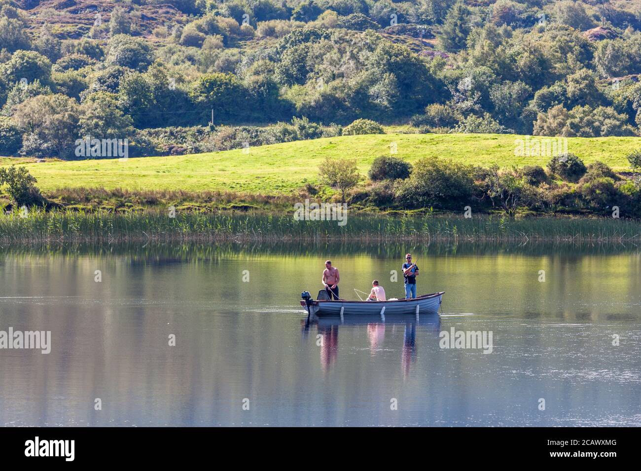 Ballingeary, Cork, Ireland. 09th August, 2020. On a hot summers day three men fish  for pike on Lough Aulla near Ballingeary, Co. Cork, Ireland. - Credit; David Creedon / Alamy Live News Stock Photo