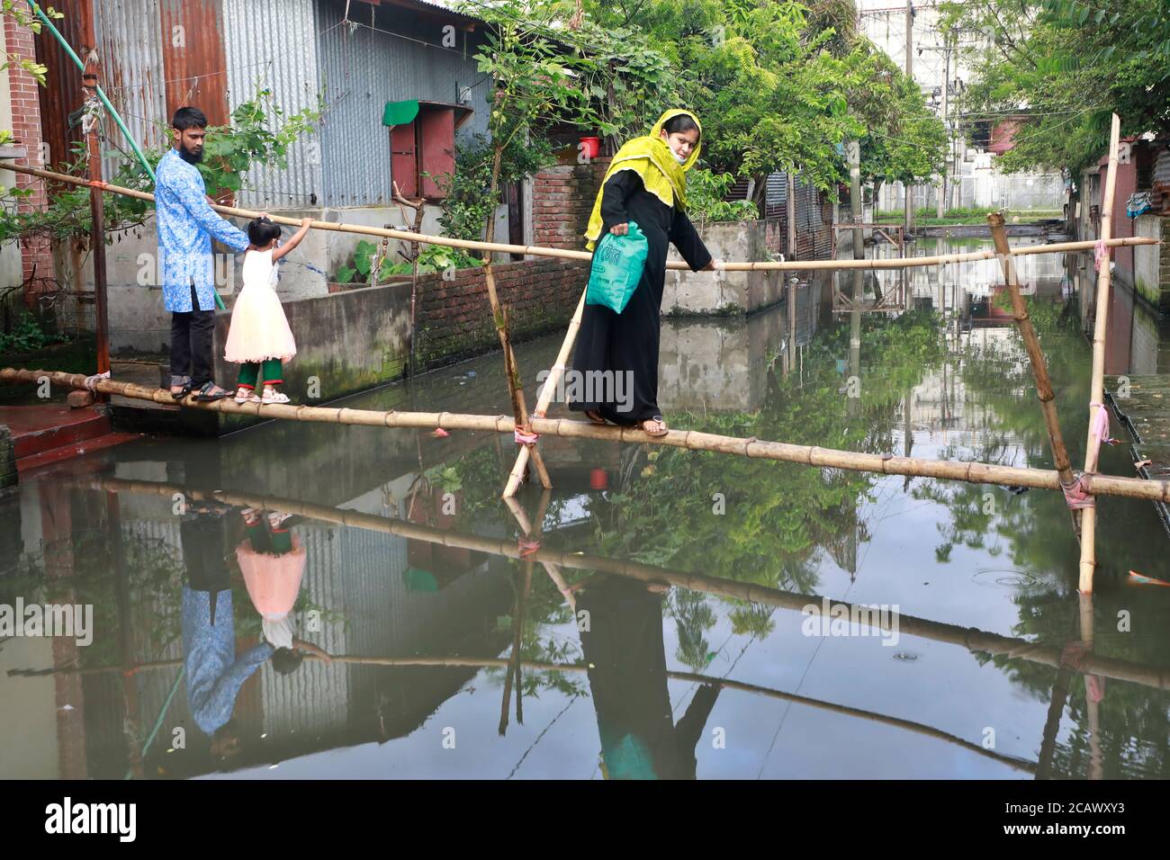 Narayanganj, Bangladesh - August 09, 2020: Bamboo bridges have become the only means of transportation for the people of the waterlogged BSCIC Jamdai Stock Photo