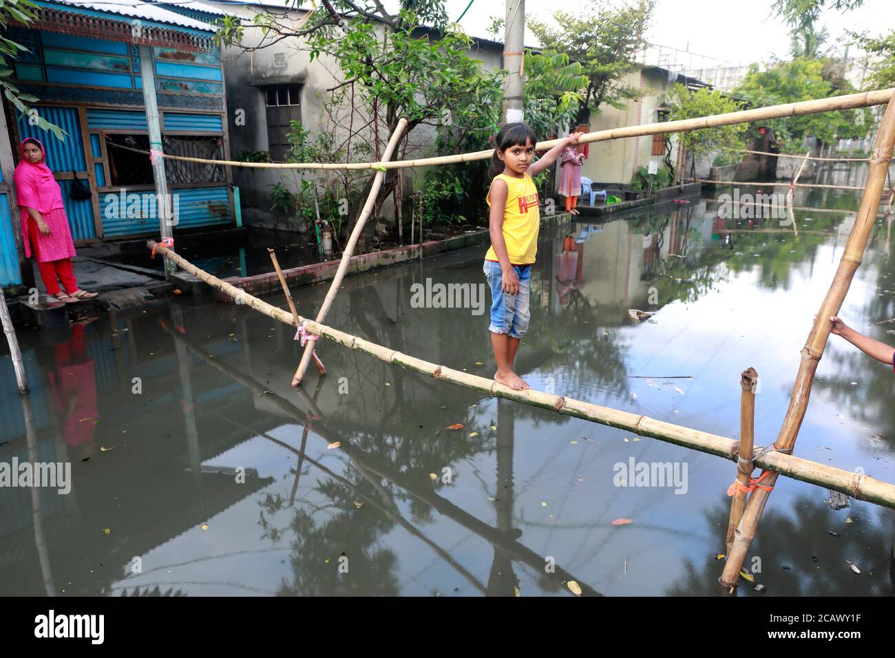 Narayanganj, Bangladesh - August 09, 2020: Bamboo bridges have become the only means of transportation for the people of the waterlogged BSCIC Jamdai Stock Photo