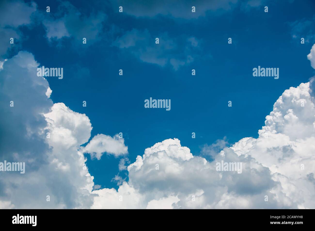 Big white fluffy cloud on blue sky background Stock Photo - Alamy