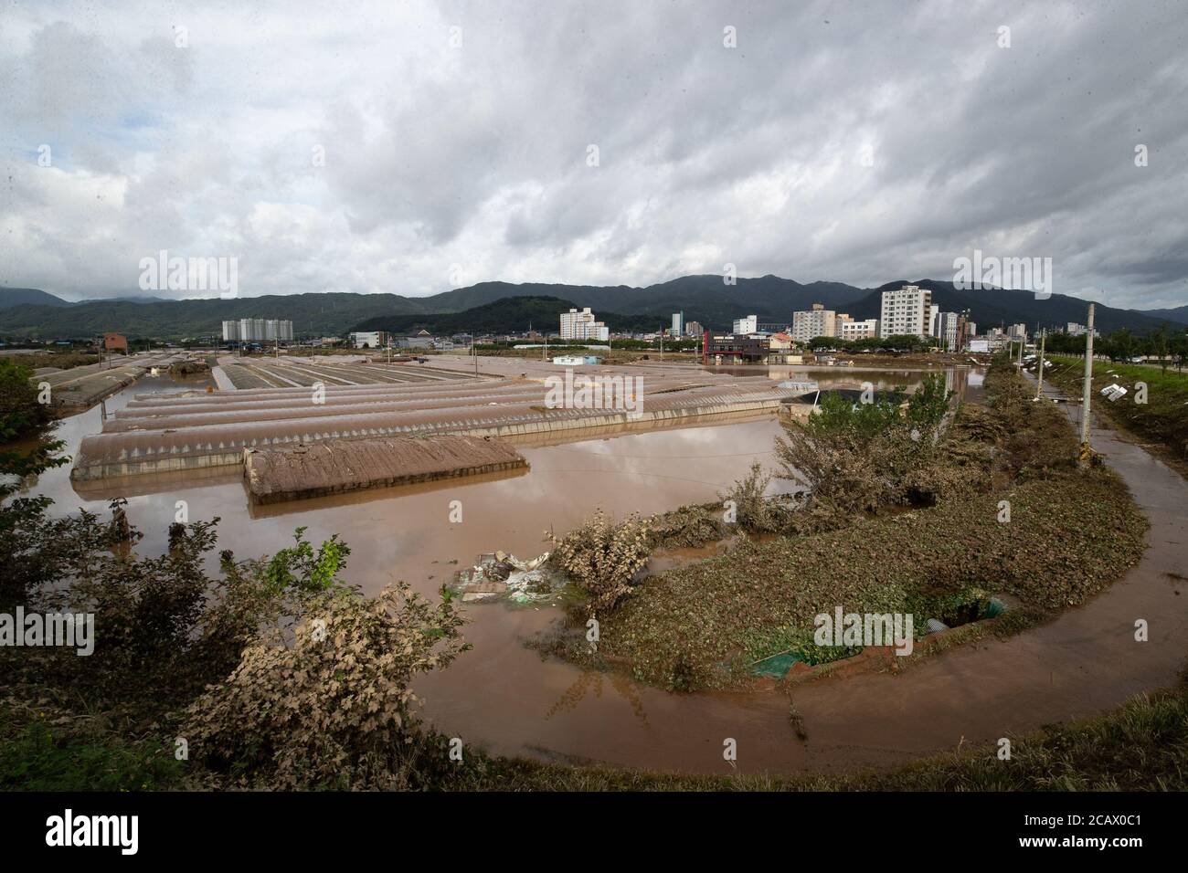 Gurye County. 9th Aug, 2020. Photo take on Aug. 9, 2020 shows a flooded farmland in Gurye county, South Jeolla province of South Korea. South Korea's death toll from heavy rain, which continued over the past seven days, rose to 30, with 12 missing and eight wounded as of 10:30 a.m. local time Sunday, according to the Central Disaster and Safety Countermeasure Headquarters. Credit: Lee Sang-ho/Xinhua/Alamy Live News Stock Photo