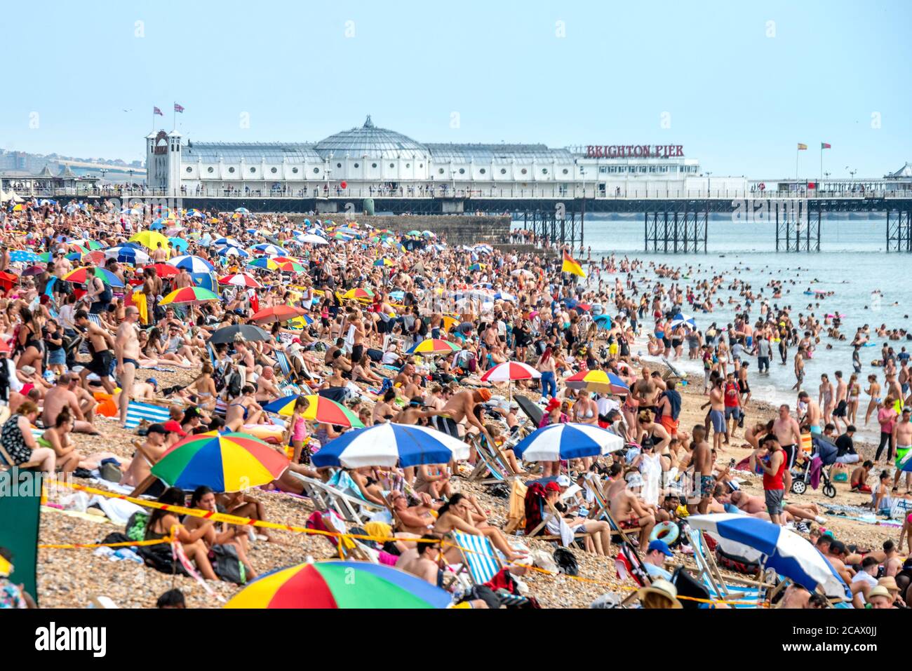 Brighton UK, August 9th 2020: Crowds on the seafront of Brighton and Hove enjoying the record temperatures and scorching sunshine Credit: Andrew Hasson/Alamy Live News Stock Photo