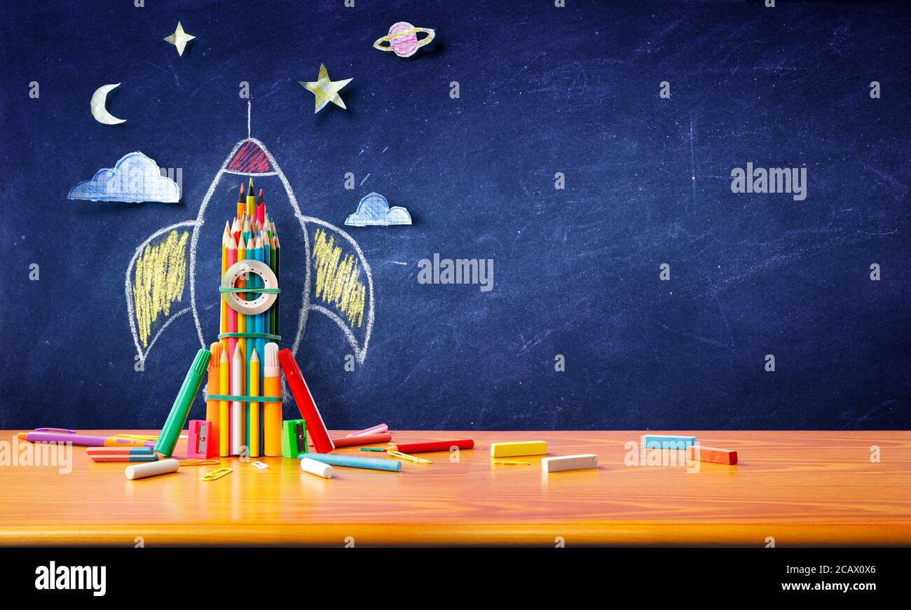Startup Concept - Rocket Sketch On Blackboard With Colorful Pencils - Back To School Stock Photo