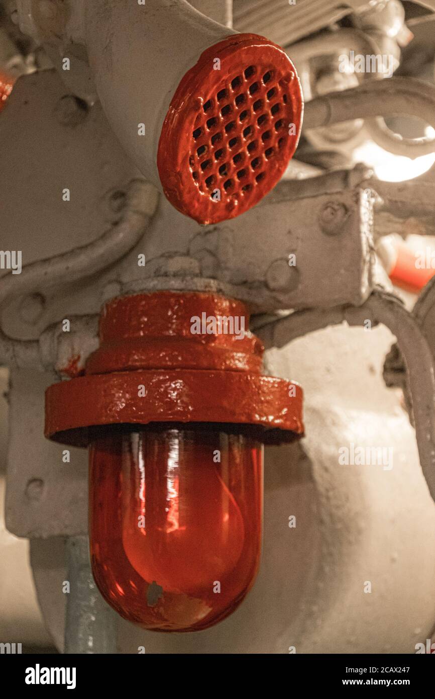 Red alarm light and speaking tube onboard a historical submarine made in Nazi Germany. Royalty free stock photo. Stock Photo