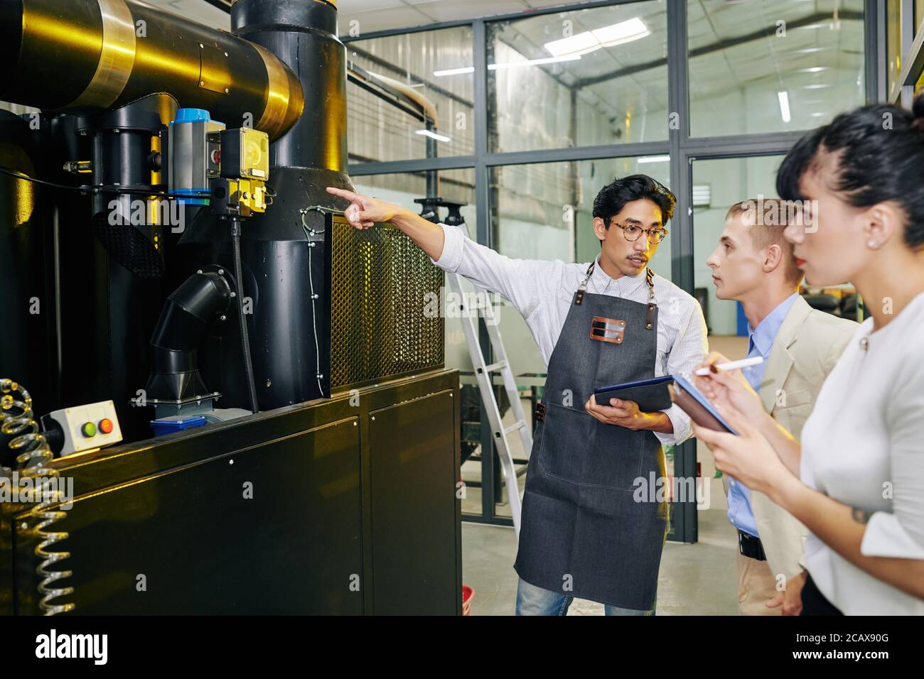 Coffee roastery owner explaining business people how he works with