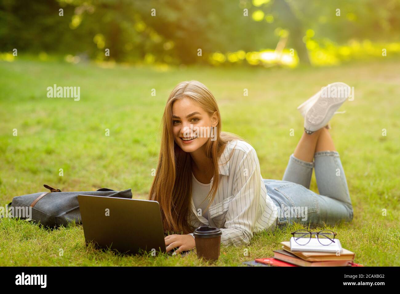 Online Education And Distance Learning. Beautiful Ten Girl Studying With Laptop Outdoors Stock Photo