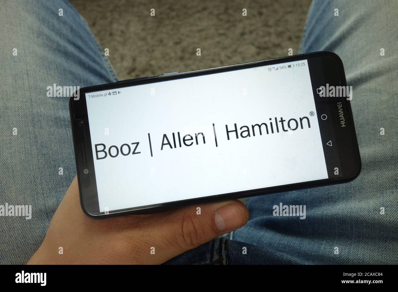 Man holding smartphone with Booz Allen Hamilton Holding Corporation
