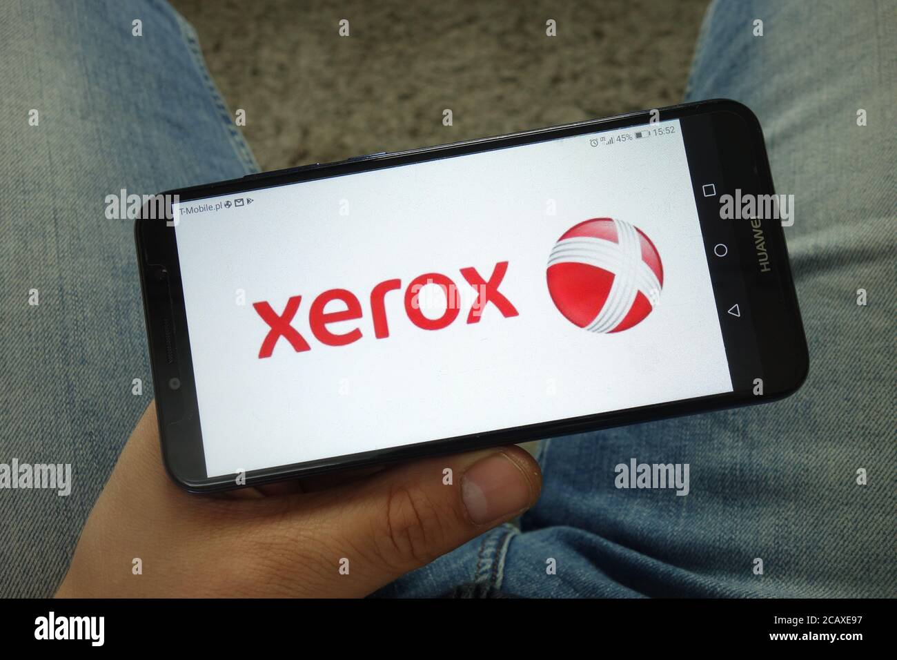Man holding smartphone with Xerox Corporation logo Stock Photo