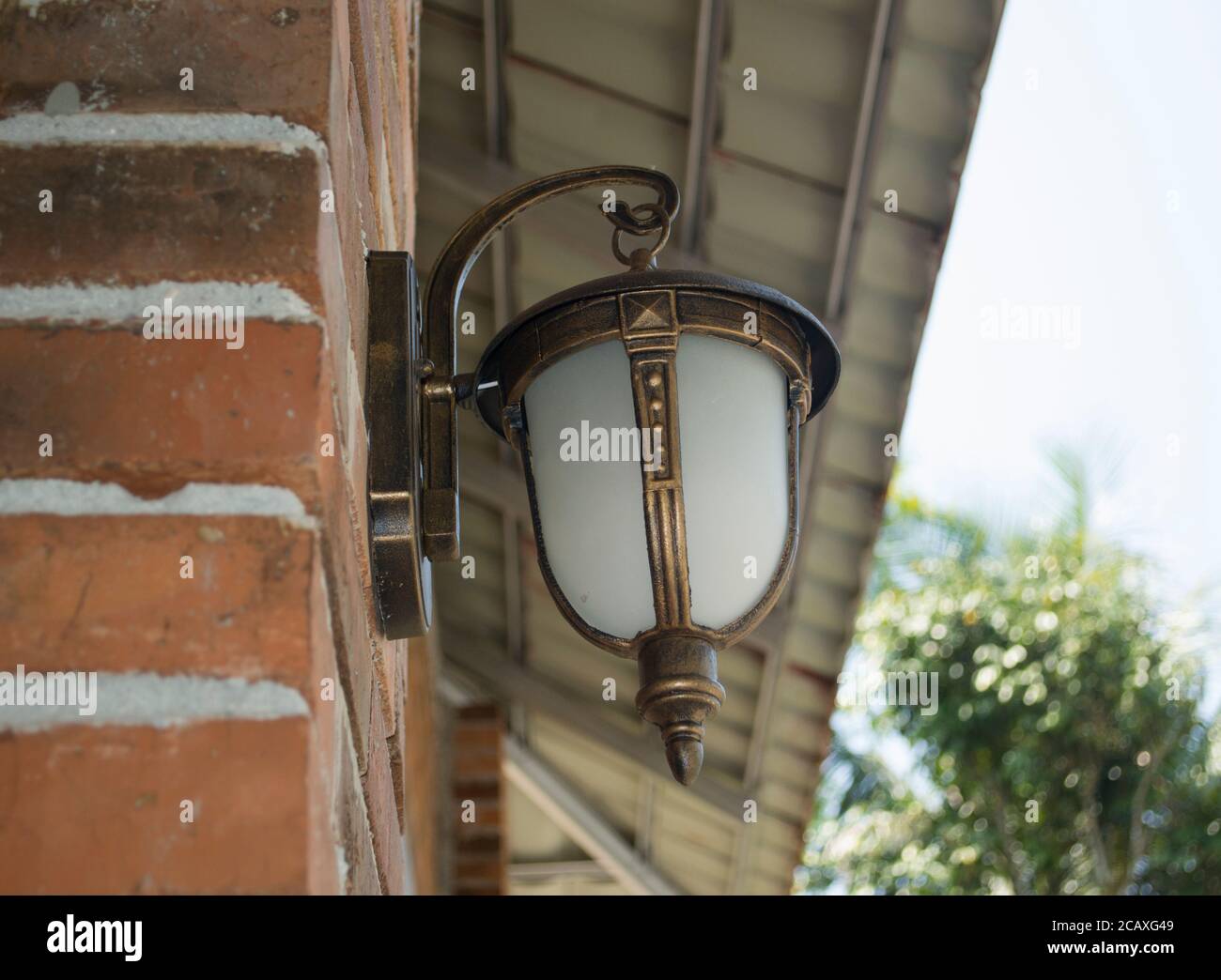 Side Angle View Of The Classic Modern Decorative Lamp Is Mounted On The Outdoor Brick Wall Stock Photo