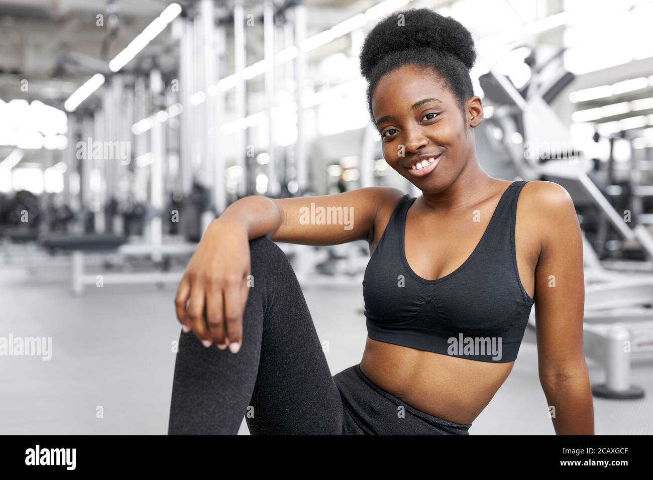 portrait of adorable african lady sitting in gym, young lady in sportswear  after crossfit exercises, posing, smile. healthy lifestyle concept Stock  Photo - Alamy