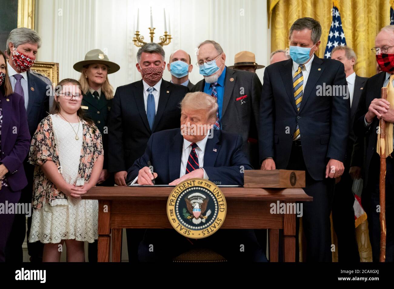 U.S. President Donald Trump signs into law the Great American Outdoors Act during an event in the East Room of the White House August 4, 2020 in Washington, D.C. Stock Photo