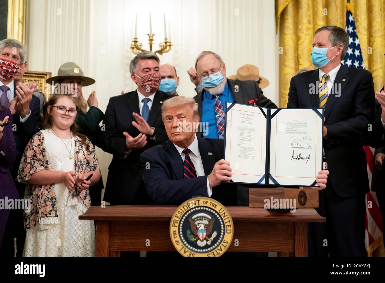 U.S. President Donald Trump holds up the signed Great American Outdoors Act during an event in the East Room of the White House August 4, 2020 in Washington, D.C. Stock Photo