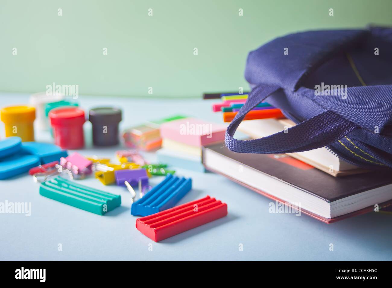School supplies and shool bag on the blue table Stock Photo