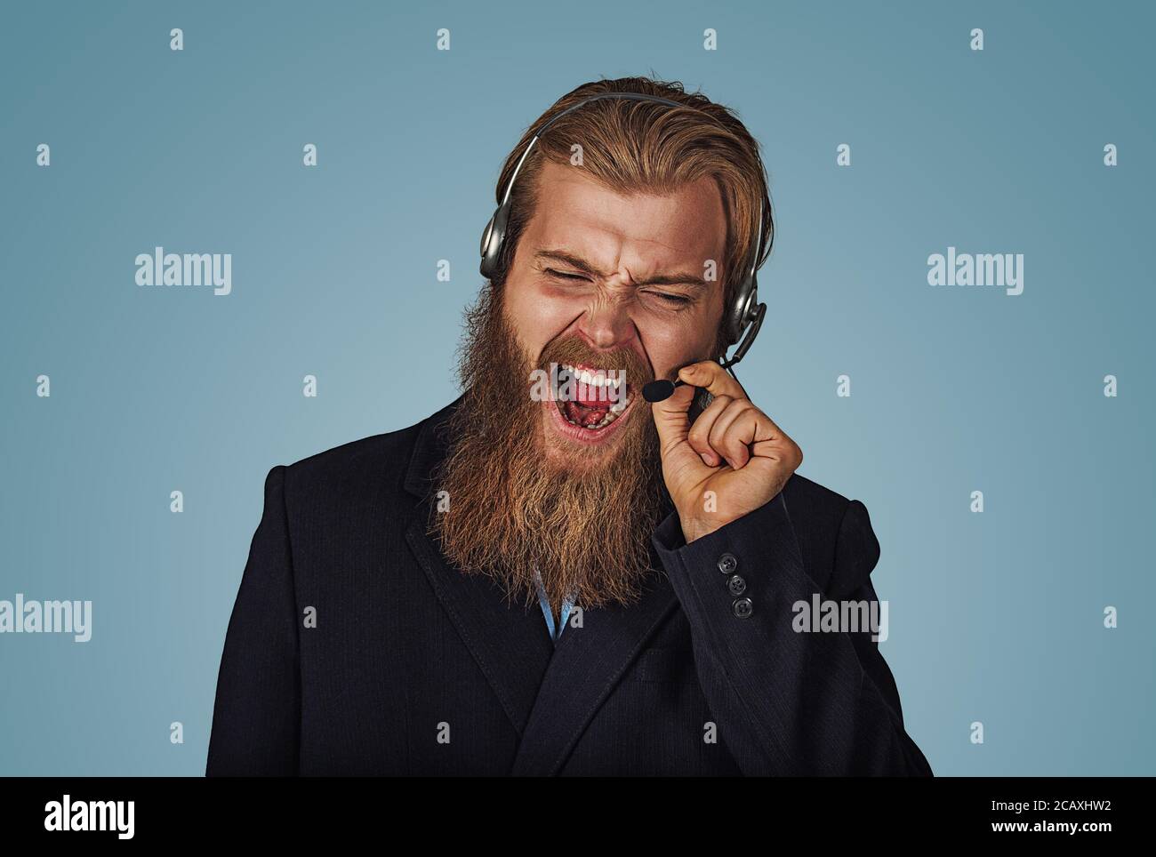 Angry Bearded hipster businessman aggressive customer support phone operator with headset, he is yelling and having a discussion with a customer isola Stock Photo