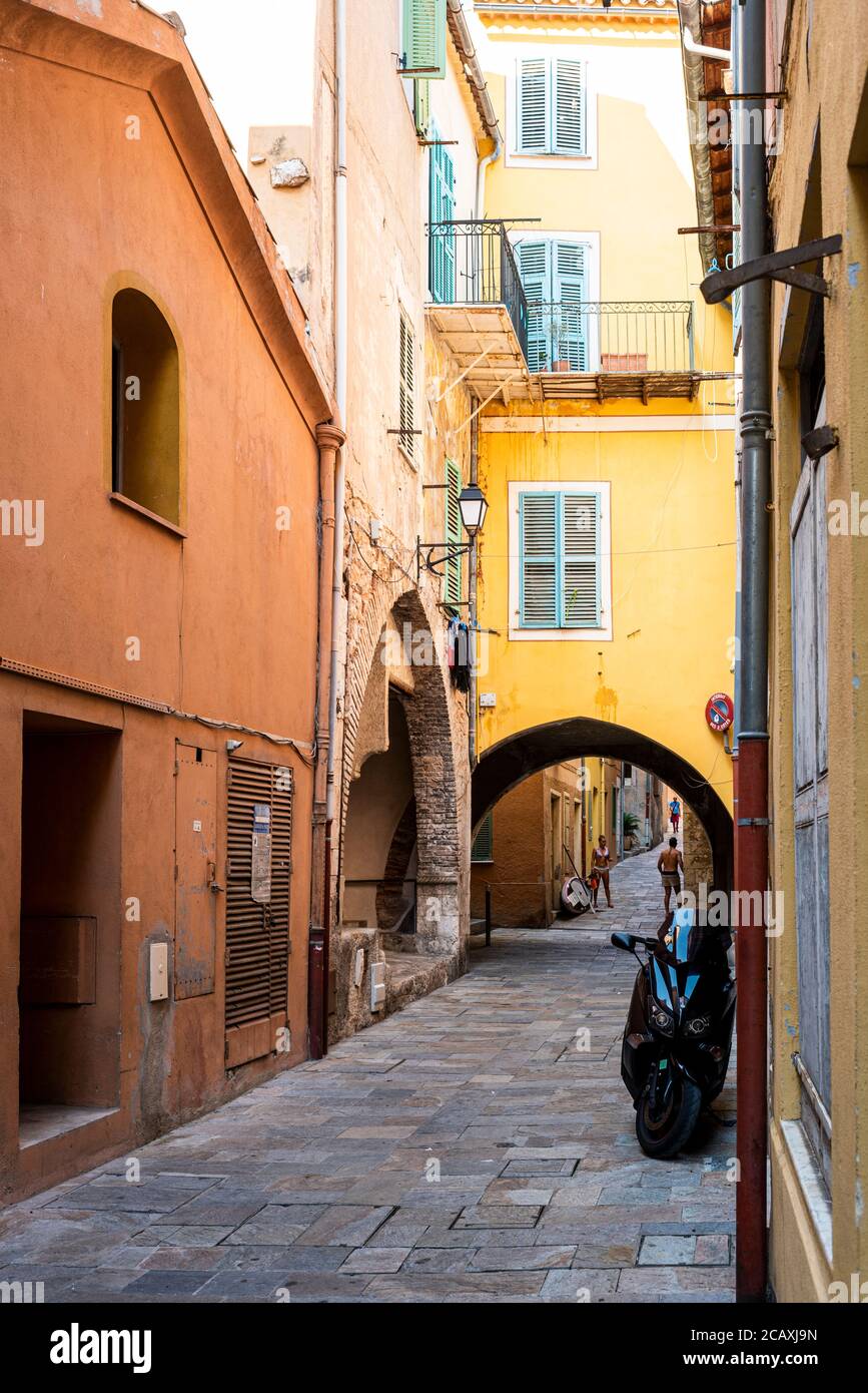 Dark foot pathway in the old city of Villefranche sur mer, a city near Nice in south of France Stock Photo