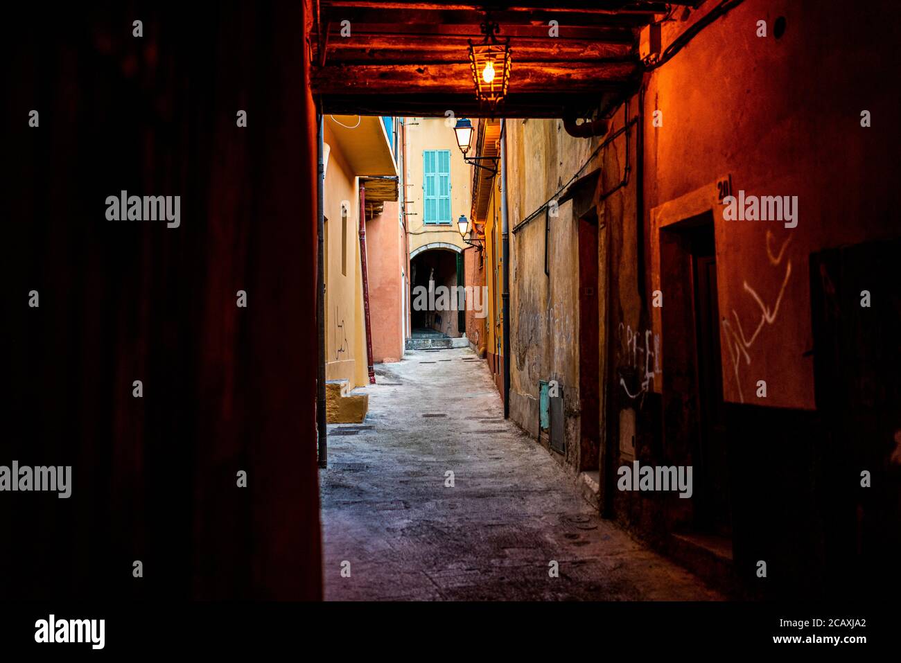 Dark foot pathway in the old city of Villefranche sur mer, a city near Nice in south of France Stock Photo