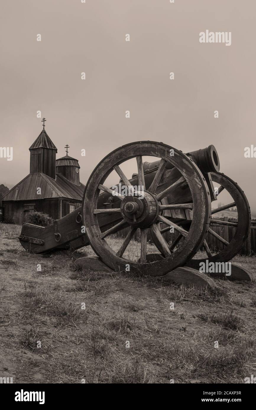 Old Fort Ross canon and church, State Park, California, USA, on a overcast day, aged photograph, sepia tone Stock Photo