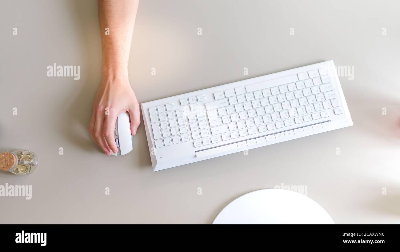 the developer works at the computer, uses the mouse Stock Photo