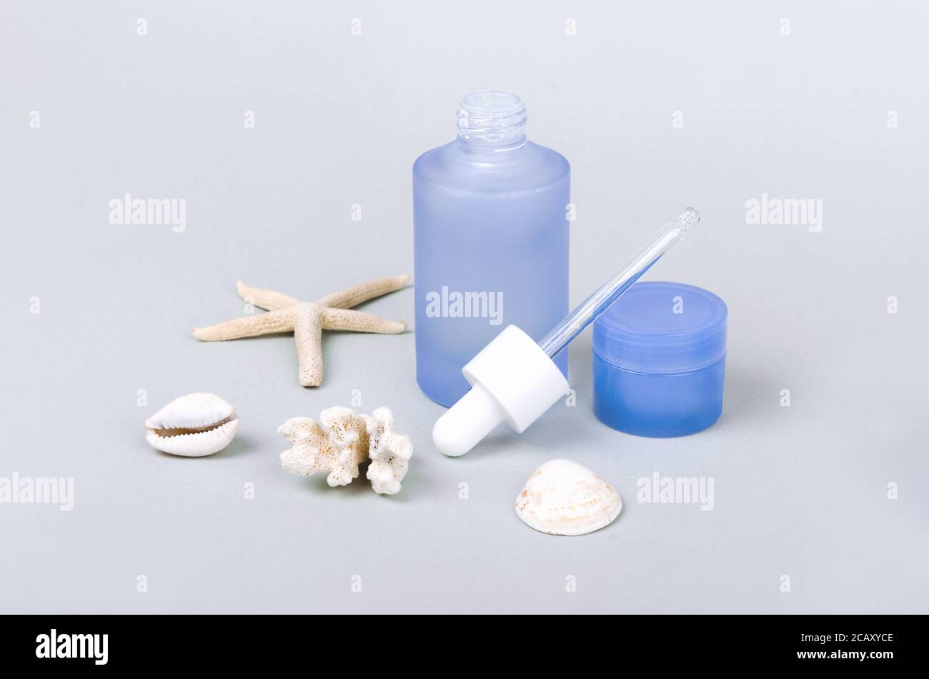 Anti pollution drops and daily care creams with dropper and seashells Stock Photo