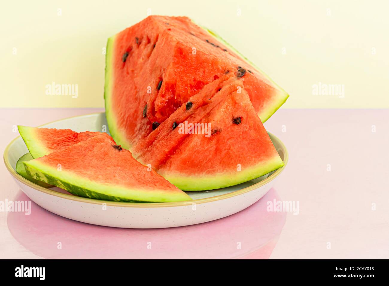 Delicious red sliced watermelon on a plate. Stock of fiber and fructose. Summer food concept. Copy space. Stock Photo