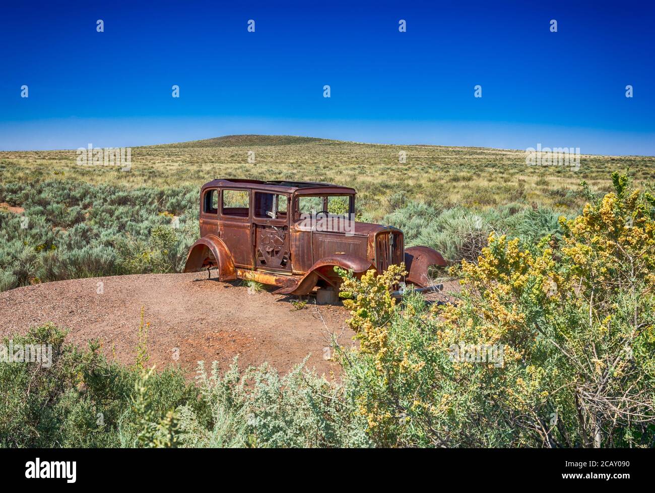 Studebaker from 1932 sits alongside a segment of historic Route 66 in Petrified Forest National Park. Stock Photo