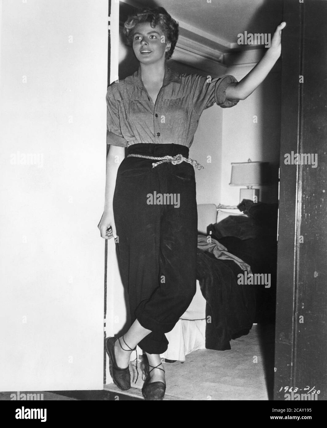 INGRID BERGMAN standing at her Dressing Room door on set candid during filming of  FOR WHOM THE BELL TOLLS 1943 director SAM WOOD novel ERNEST HEMINGWAY screenplay DUDLEY NICJHOLS Paramount Pictures Stock Photo