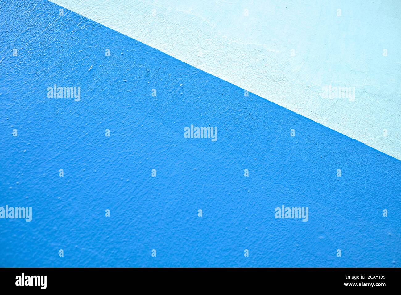 Light tone blue bands diagonal design element, painted wall pattern, material for banners and backgrounds. Stock Photo
