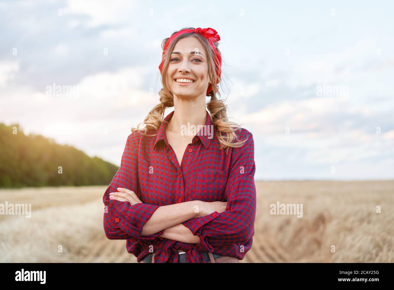 Woman farmer standing farmland smiling Female agronomist specialist farming agribusiness Happy positive caucasian worker agricultural field dressed re Stock Photo