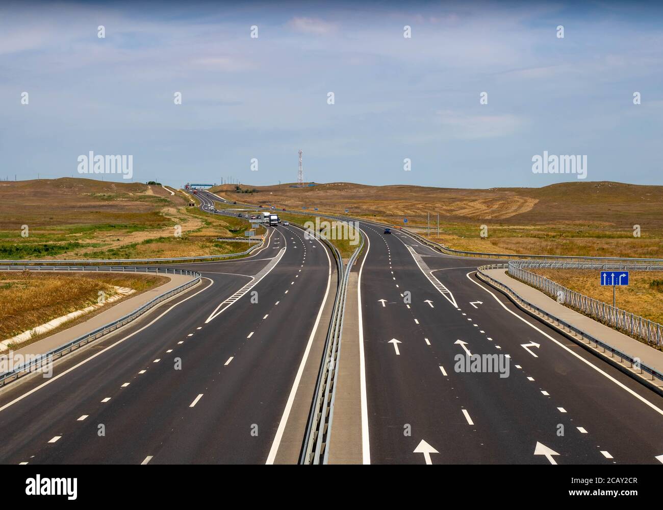 highway in steppe against a blue sky,long road stretching out into the distance Stock Photo