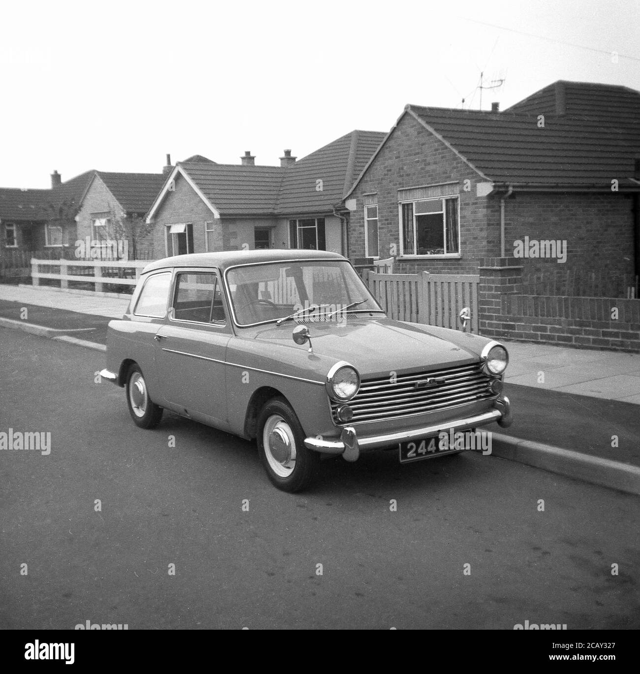 1960, historical, An Austin A40 Farina motorcar parked in a street of bungalows,  England, UK. A small, economy car, made by the British Motor Coporation (BMC) it was named the Austin A40 Farina, reflecting the new design by the Italian 'Battista Farina's Pinin Farina Turin studio.  The car shown here is the Mark 1 Saloon, made between 1958 and 1961. Stock Photo