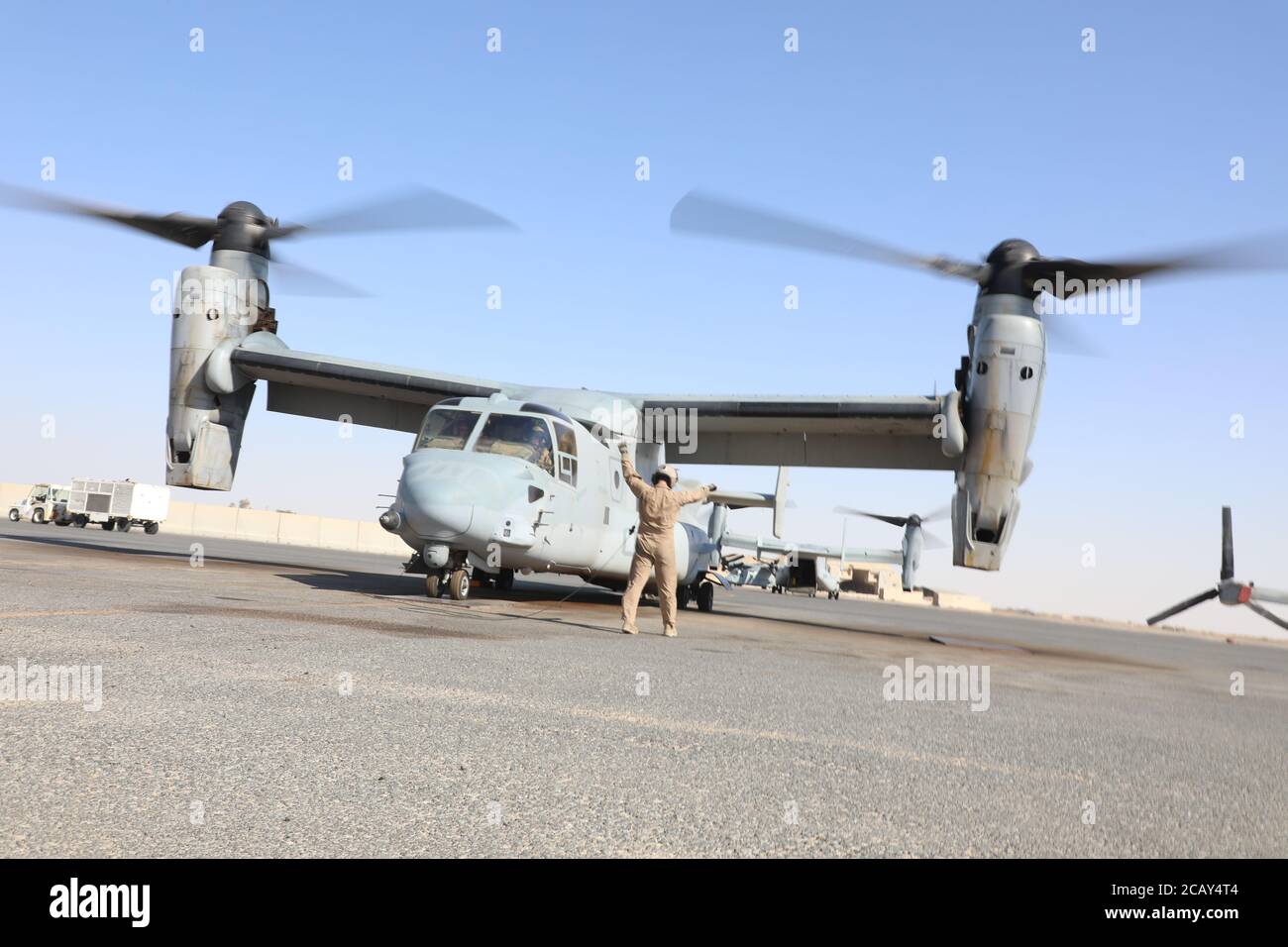 A U.S. Navy crew chief with Marine Medium Tiltrotor Squadron 166 (Reinforced,) assigned to the Special Purpose Marine Air-Ground Task Force - Crisis Response - Central Command 20.2, conducts preflight inspection for a MV-22B Osprey in Kuwait, Aug. 4, 2020. The SPMAGTF-CR-CC is a crisis response force, prepared to deploy a variety of capabilities across the region. (U.S. Marine Corps Photo by Cpl. Cutler Brice) Stock Photo